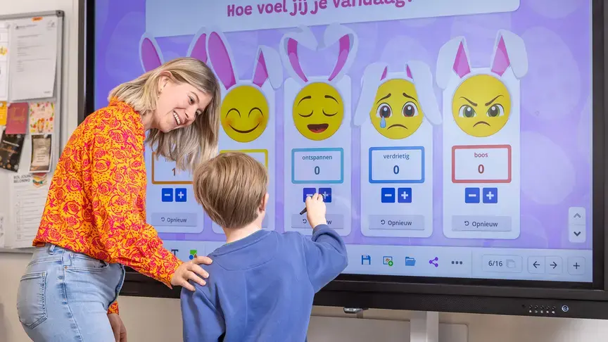 Leerkracht en leerling werken samen met een digitaal schoolbord over gevoelens.